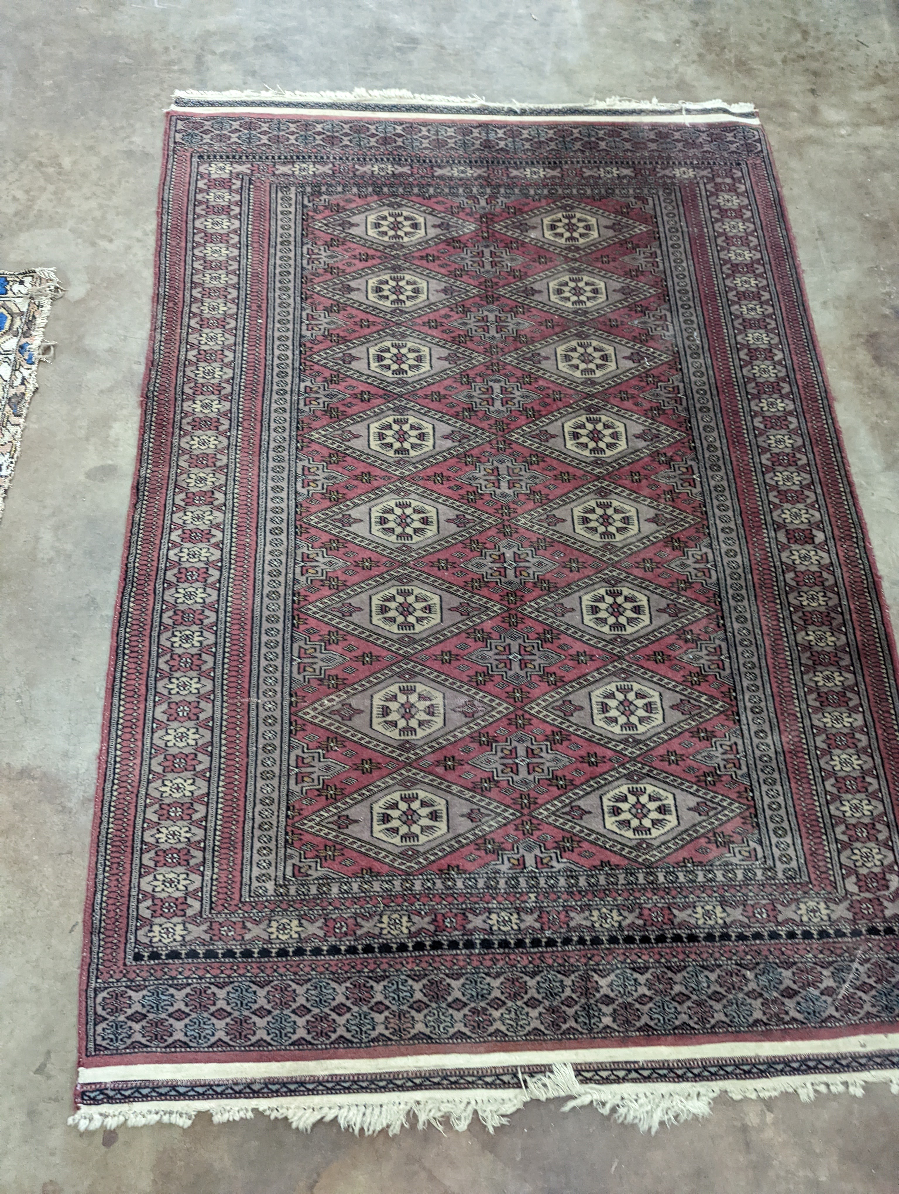 A Tekke Bokhara red ground rug, woven with rows of elephant feet, 180 x 126cm